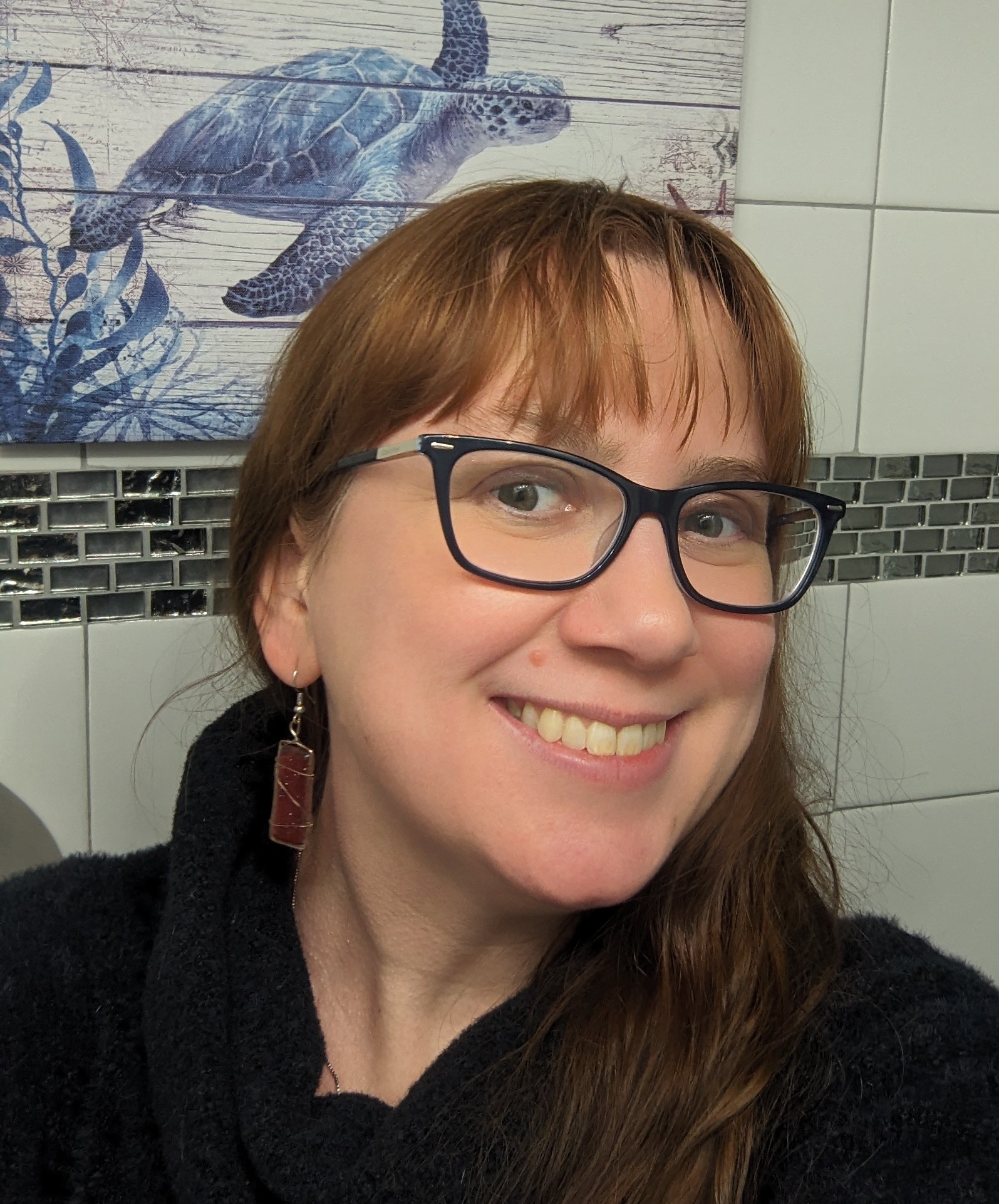 Female professor wearing glasses and smiling